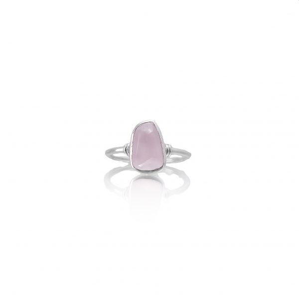 A sterling silver ring with an irregular-cut rose quartz gemstone, displayed against a white background.